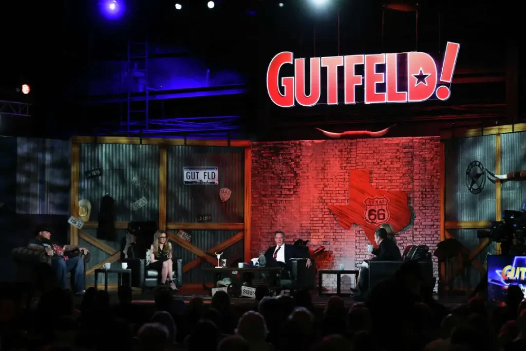Kat Timpf and Greg Gutfeld interacting on the Gutfeld! show set.